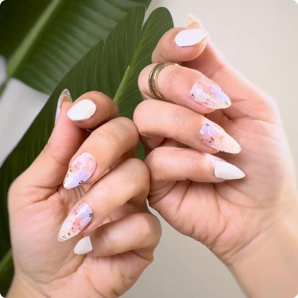 Petals manicure set: mix of solid white and translucent nails with pink, yellow floral accents