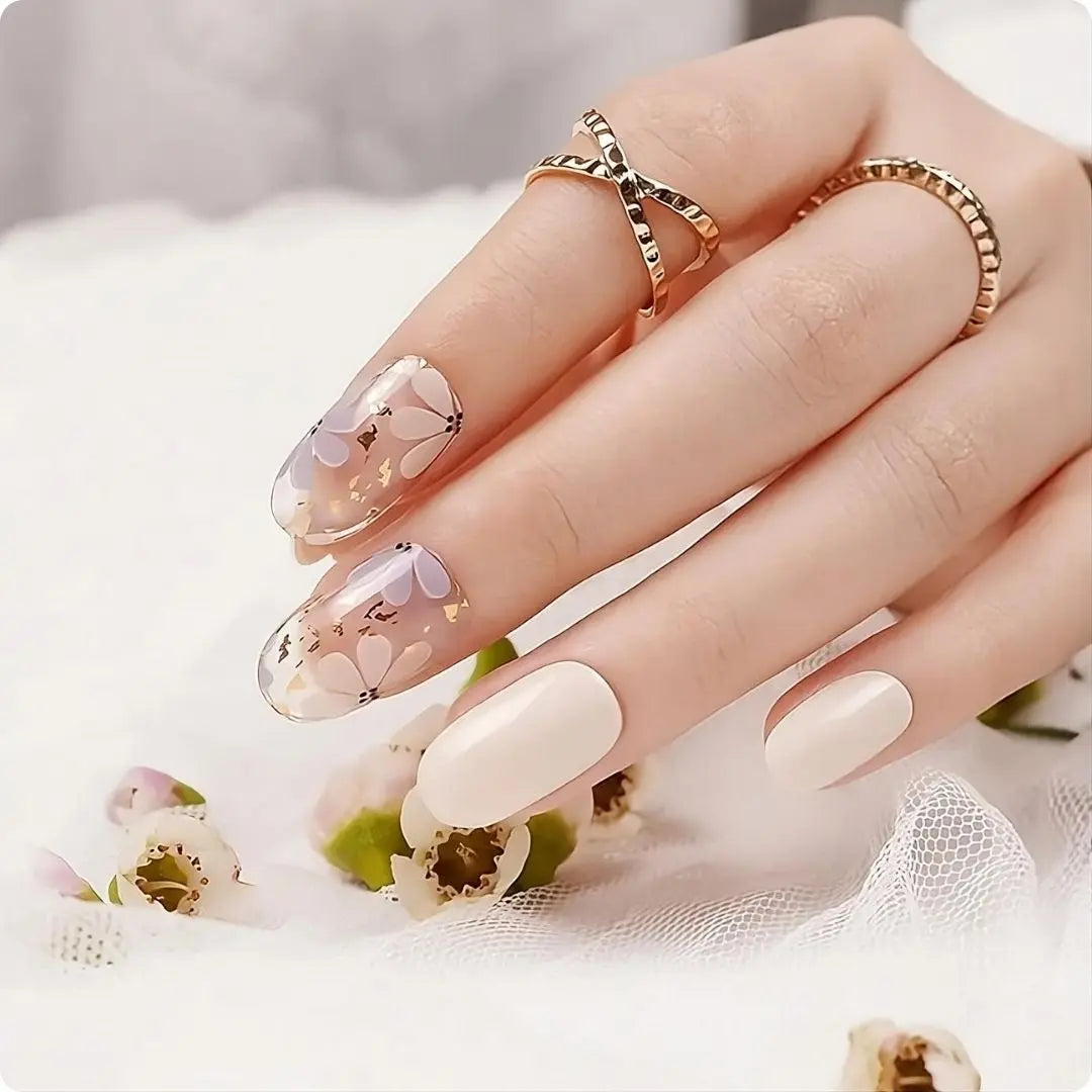 Petals nails: glossy nude base with white accent nails and pastel petal flowers on curved tips