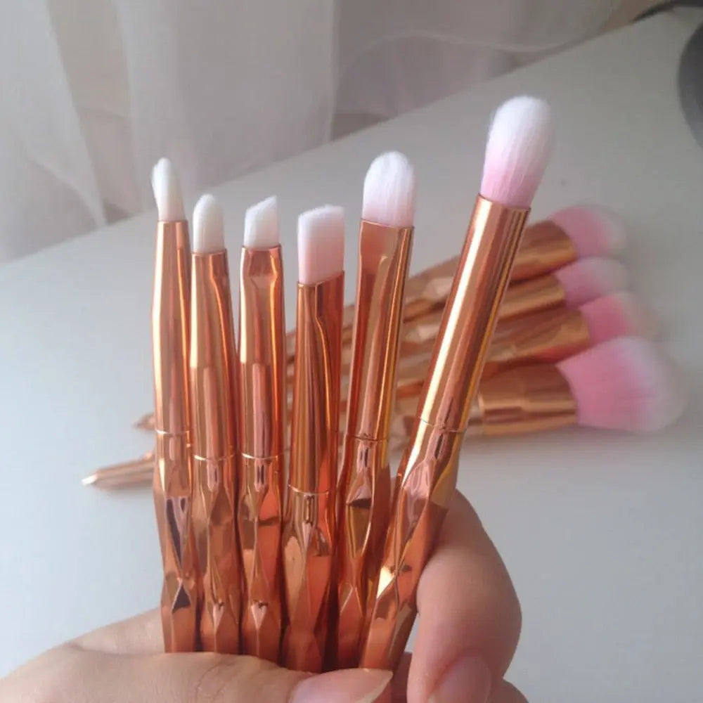 Set of makeup brushes with rose-gold mirrored handles and pink brush heads