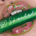 Green lip gloss on lips with glitter sparkle, close-up