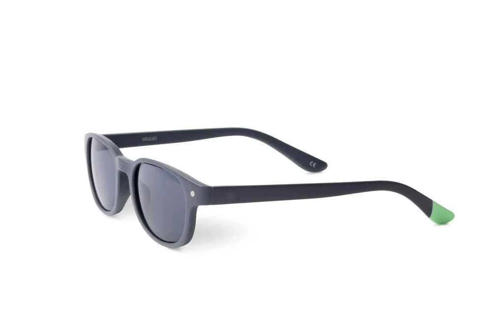 Kara slate sunglasses from angled front, rounded dark lenses and green temple inserts