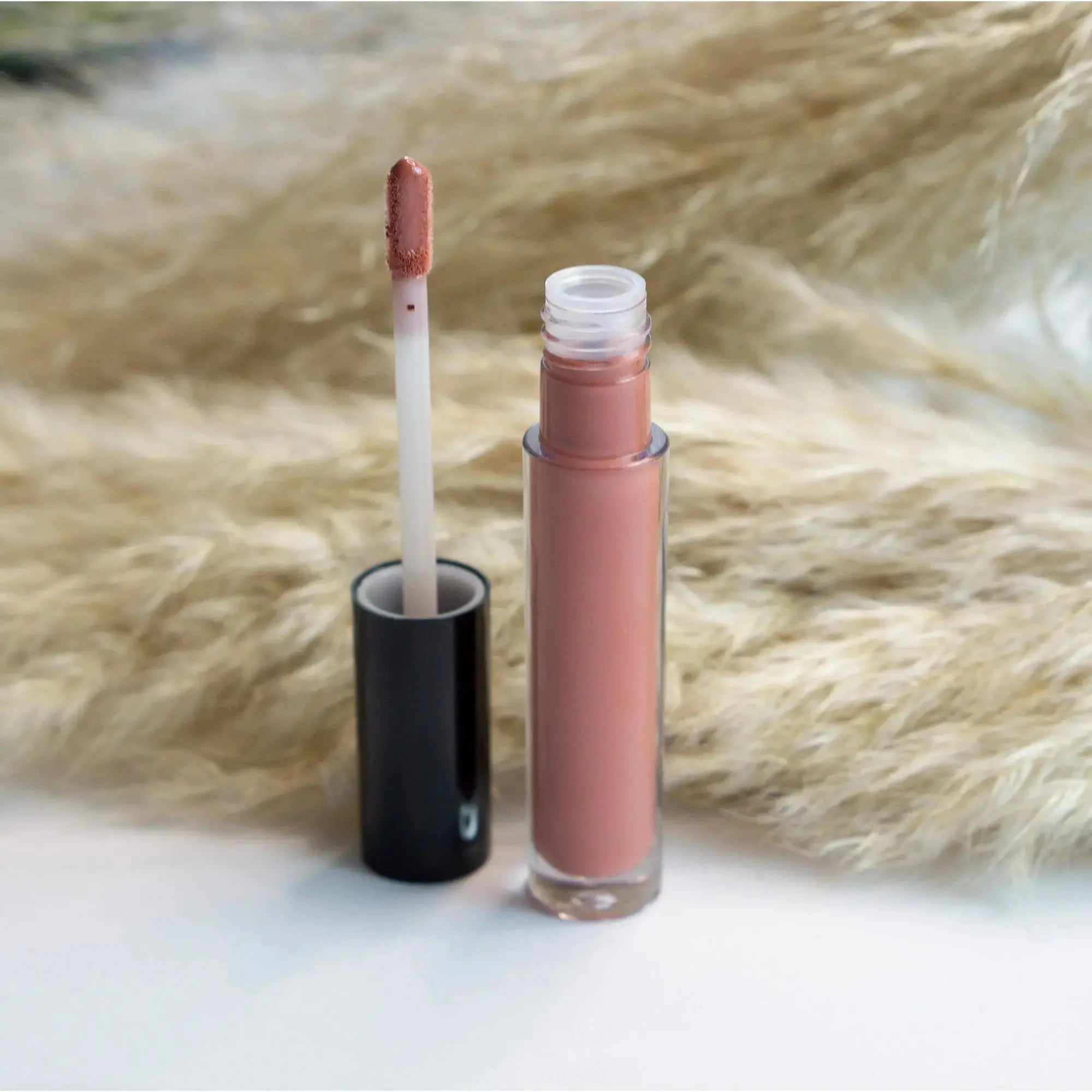 Rouge lip gloss with wand applicator and mauve-pink tube, glossy finish