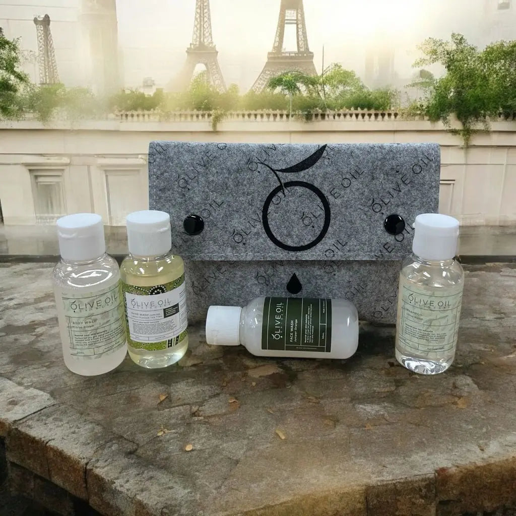 Sample pack with gray felt pouch and four olive oil skincare bottles plus lotion tube