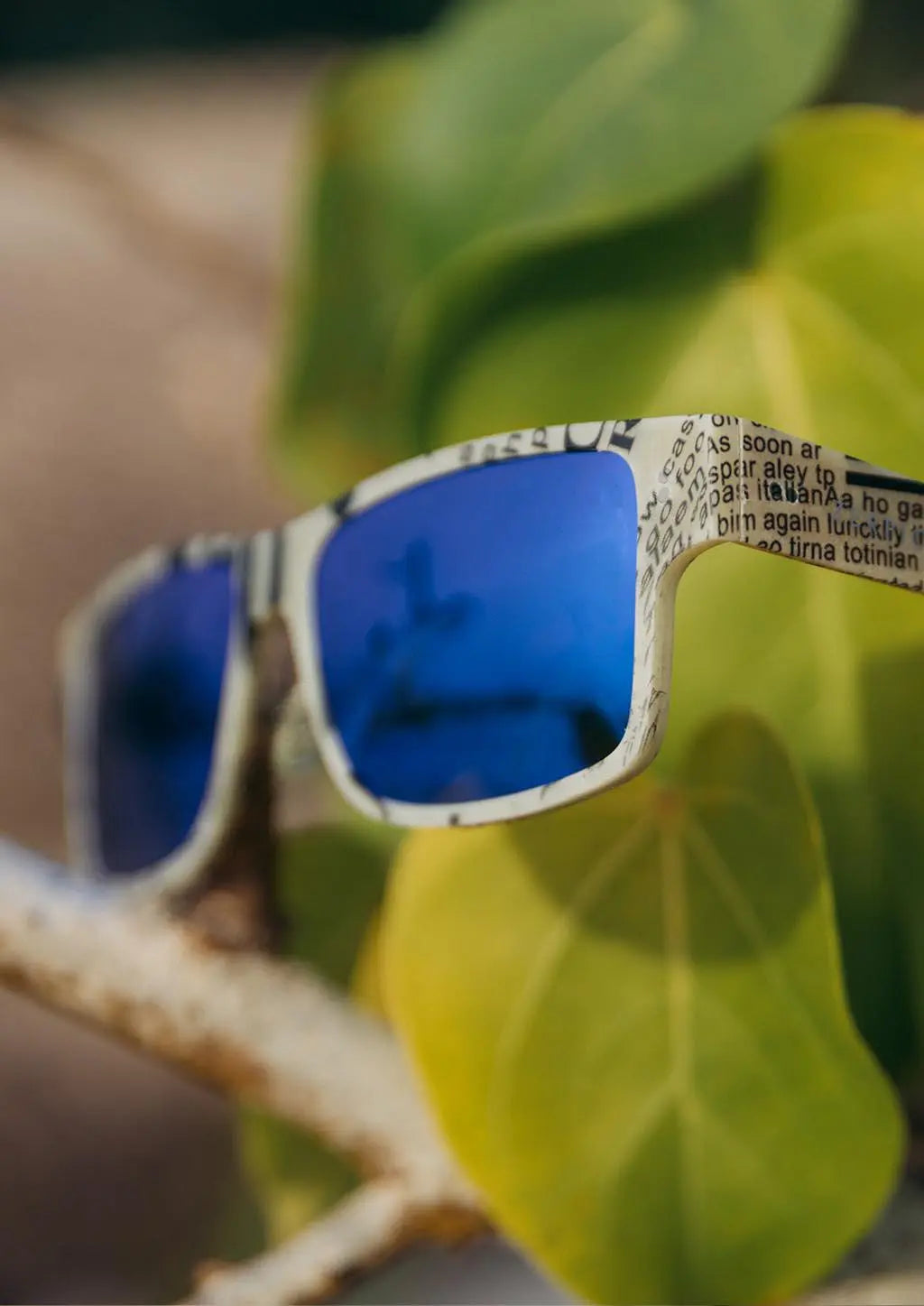 ReVision square sunglasses, close-up raw paper frame and blue mirror lenses