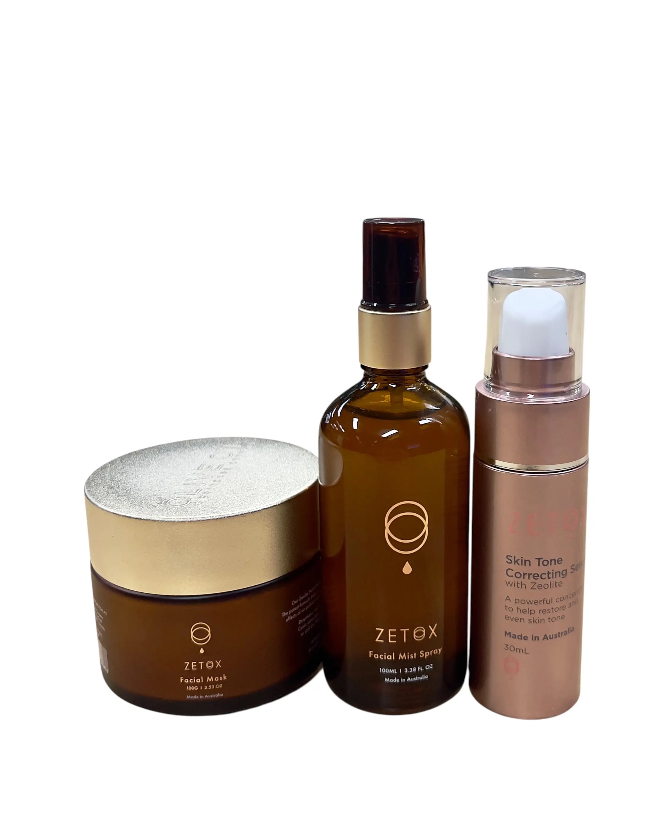 Zetox set with gold-lid clay mask jar, amber facial mist spray, beige skin tone serum bottle
