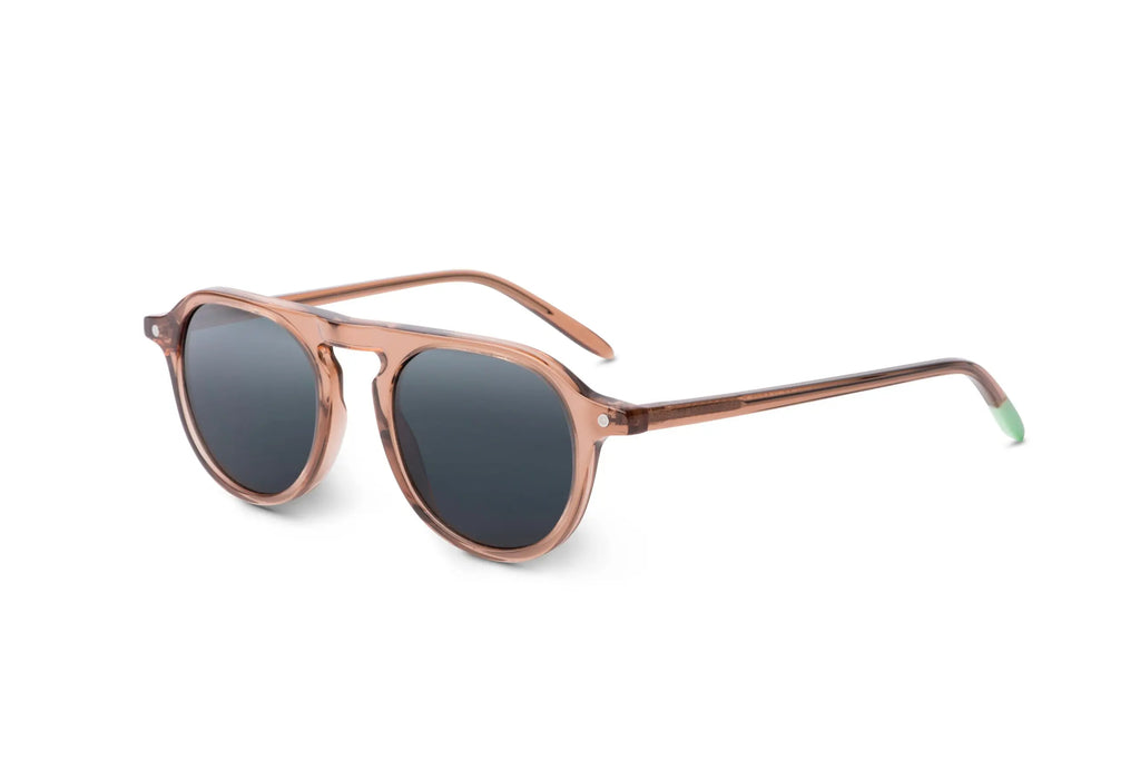 Zingaro Toffee sunglasses, side view: round pink frames with dark lenses