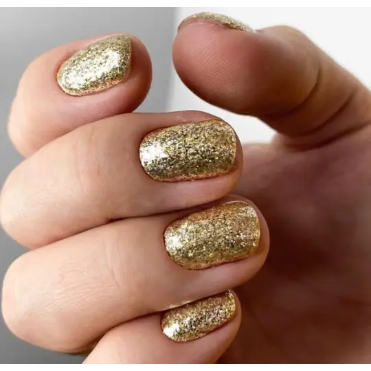Hands with metallic gold leaf glitter gel nails, short rounded almond shape