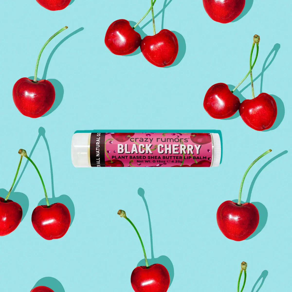 Black Cherry lip balm tube with red cherries scattered around