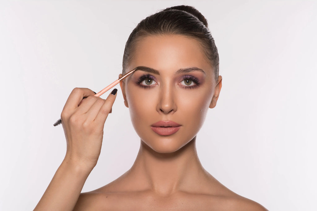 Eyebrow gel being brushed onto eyebrows for shaped, groomed brows