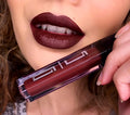 Matte Liquid Lipstick 35 in deep burgundy, applicator held near lips