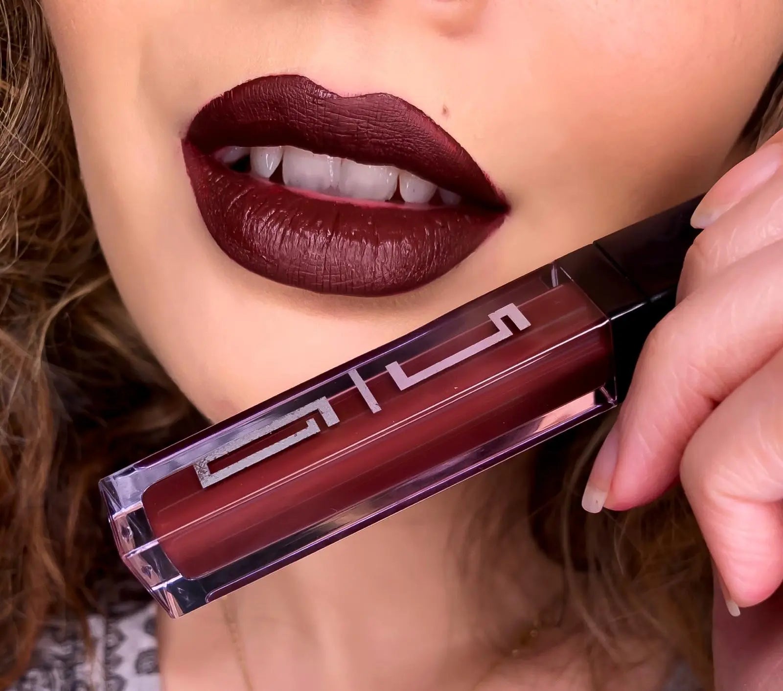 Matte Liquid Lipstick 35 in deep burgundy, applicator held near lips