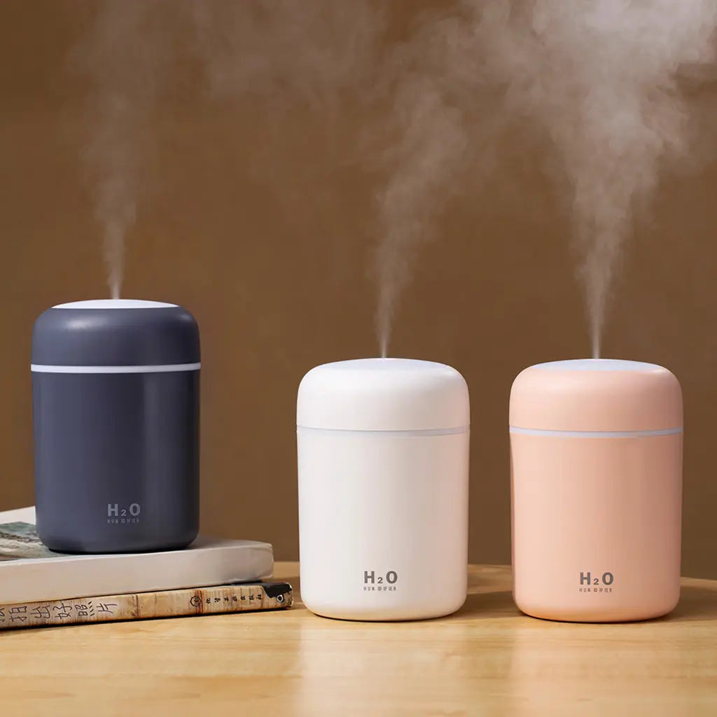 Humidifier aroma diffuser in dark grey, white and pink with mist output
