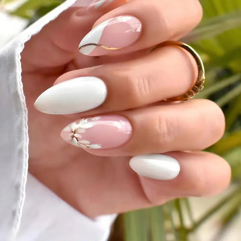 Press-on nails with nude base, white tips, and delicate floral accents