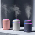 Portable humidifier aroma diffuser: pink, white & dark grey bases with glowing top