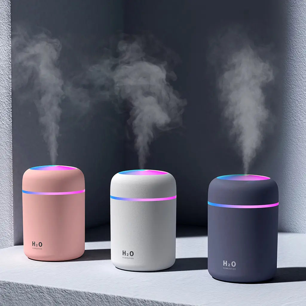 Portable humidifier aroma diffuser: pink, white & dark grey bases with glowing top