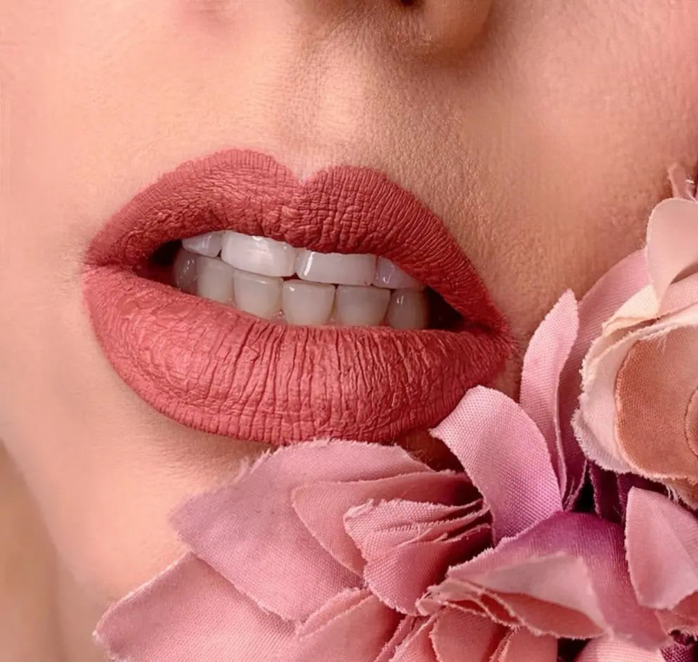 Matte liquid lipstick on lips, rich rose-brown matte finish