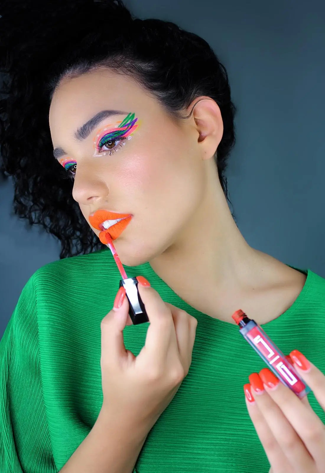 Eyeliner being applied: black pencil with red tip held near eye