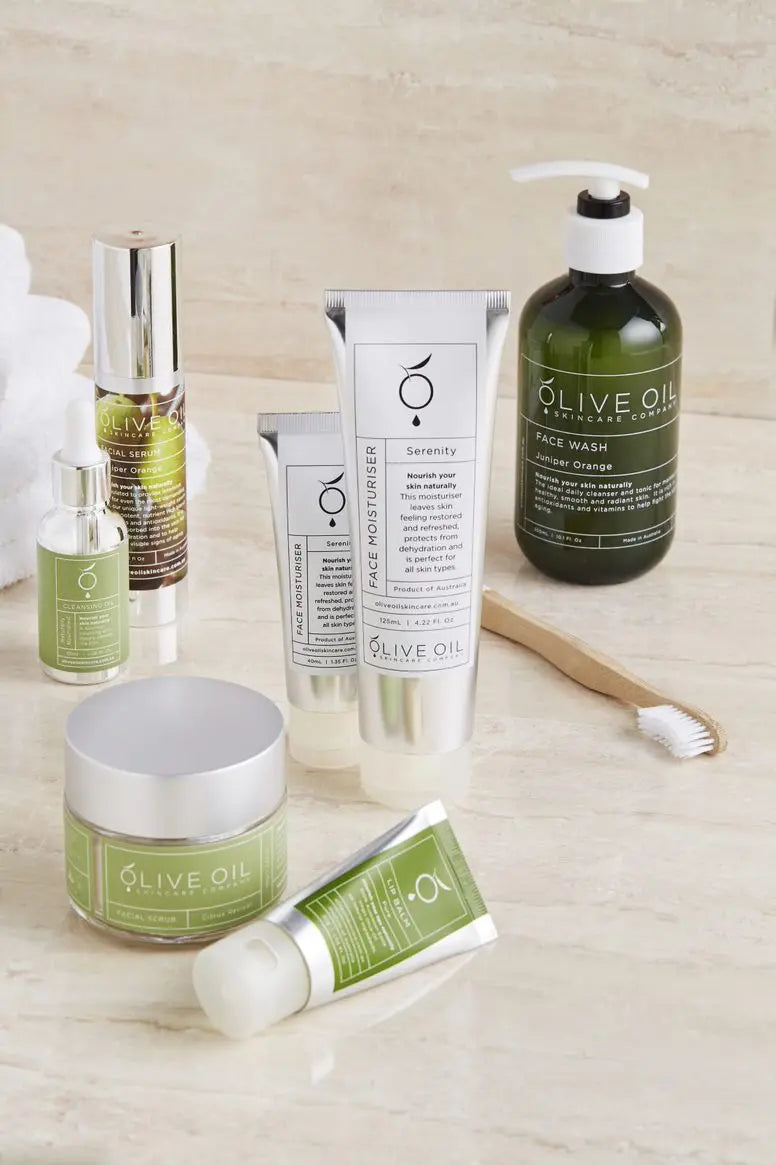 Juniper Orange facial serum 40 ml shown with other skincare bottles and creams