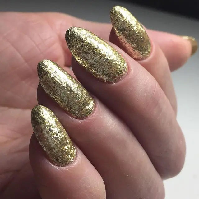 Gold leaf glitter gel nails with metallic gold sparkle almond shapes