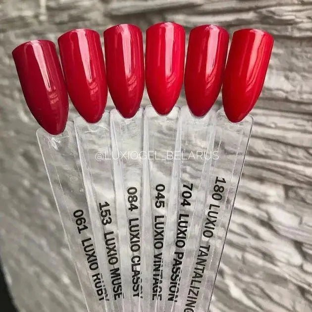 Red glossy nail tips on display sticks for Passion gel shade