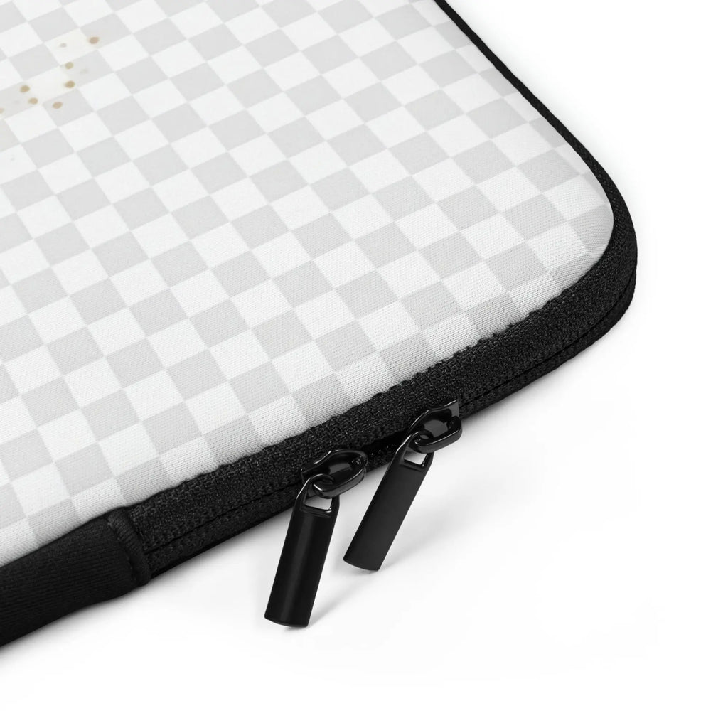 Laptop sleeve close-up of black zipper with two metal pulls on white checkered fabric