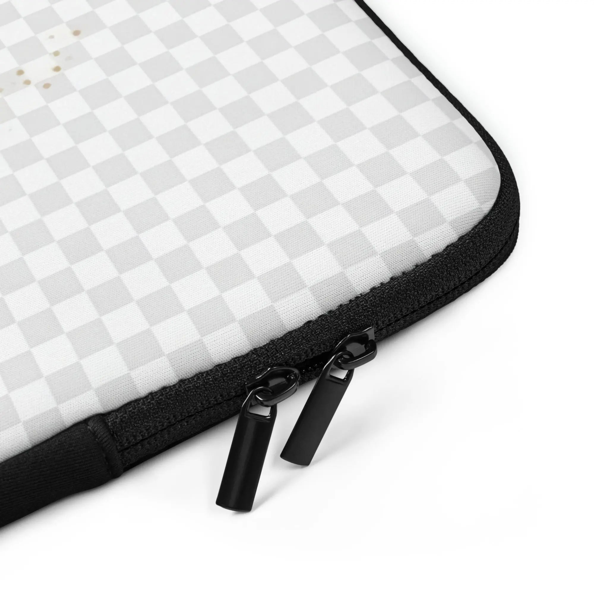 Laptop sleeve close-up of black zipper with two metal pulls on white checkered fabric