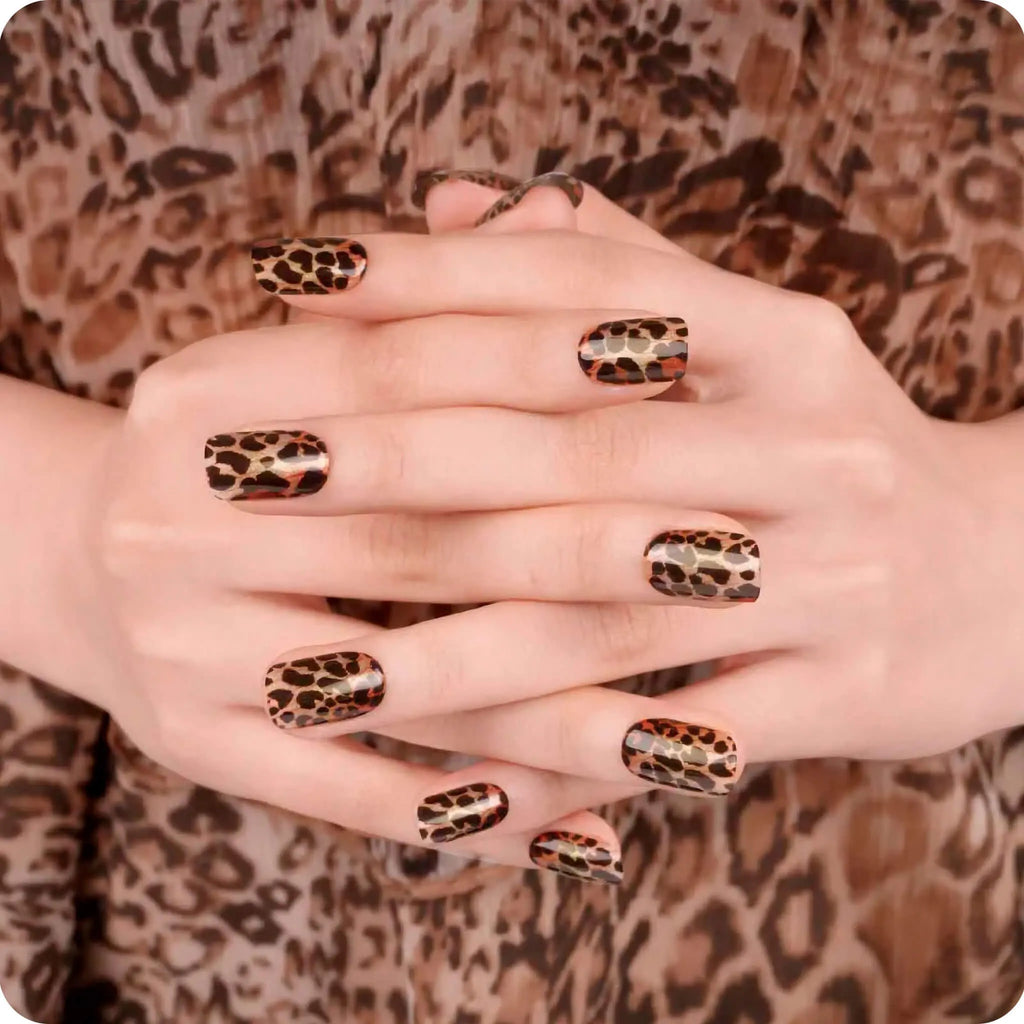 Leopard print nail design on overlapping hands, glossy almond nails with spotted pattern