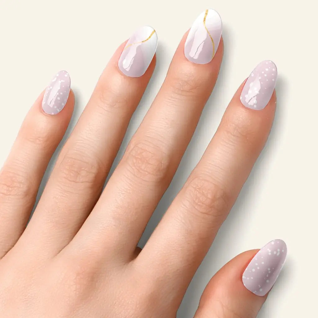 Almond nails with mauve ombré glitter and small gold accents on each nail