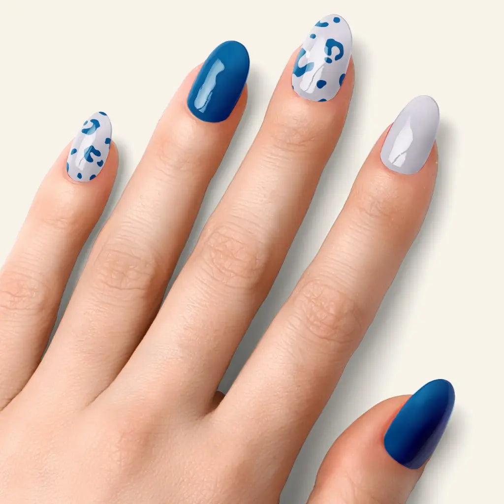 Blue leopard nails in deep blue and white, with leopard-print detail on accent tips