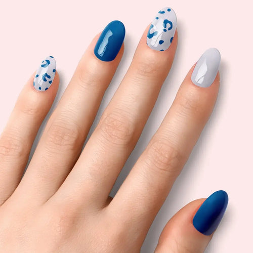 Blue leopard nail set: solid deep-blue nails and white nails with blue spots