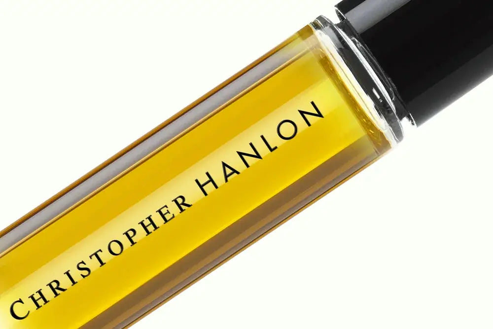 Cracked Ice Gardenia rollerball, amber glass bottle close-up with brand text